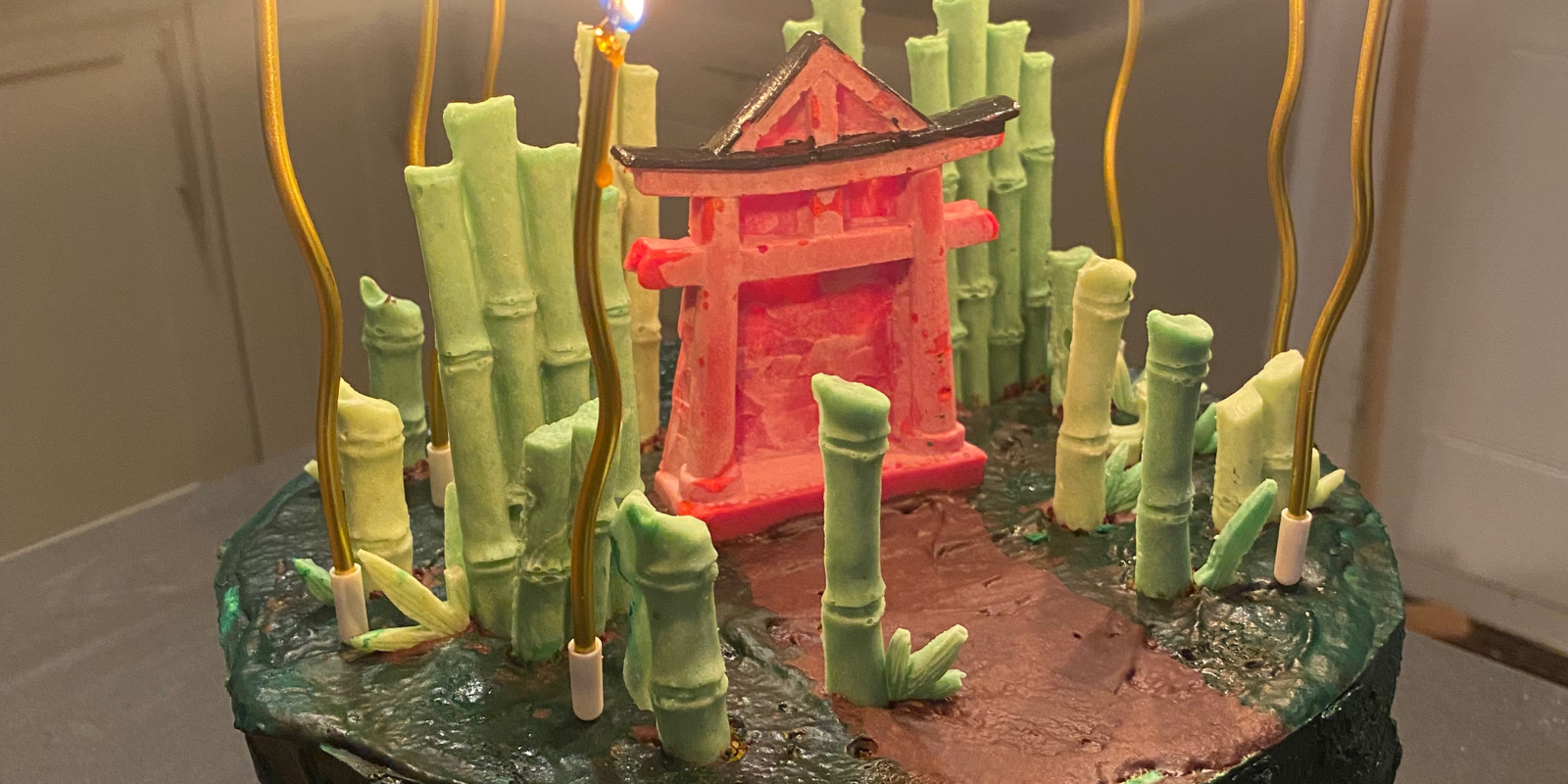 Cake with japanese torii gate and a bamboo forest. Everything is edible.