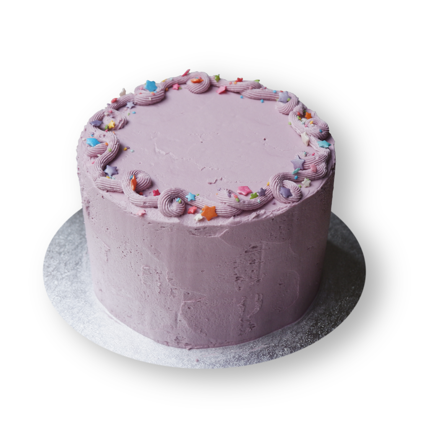 Fun lilac cake with simple piping at the top with rainbow stairs sprinkles.